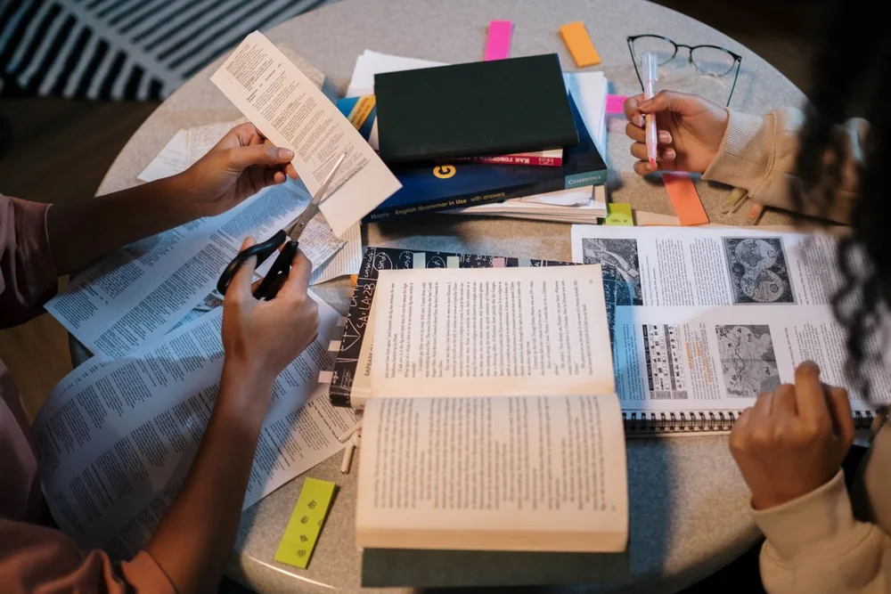 Open books and learning materials at a shared study table