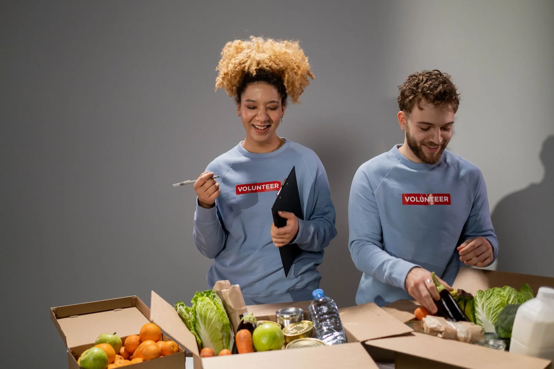 Volunteers packing fresh produce and everyday supplies